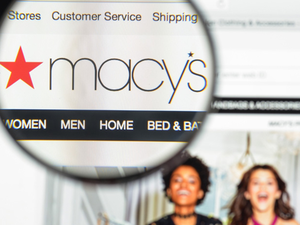 Magnifying glass showing the Macy's logo on their homepage