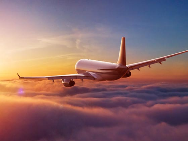 Airplane flying toward the sun